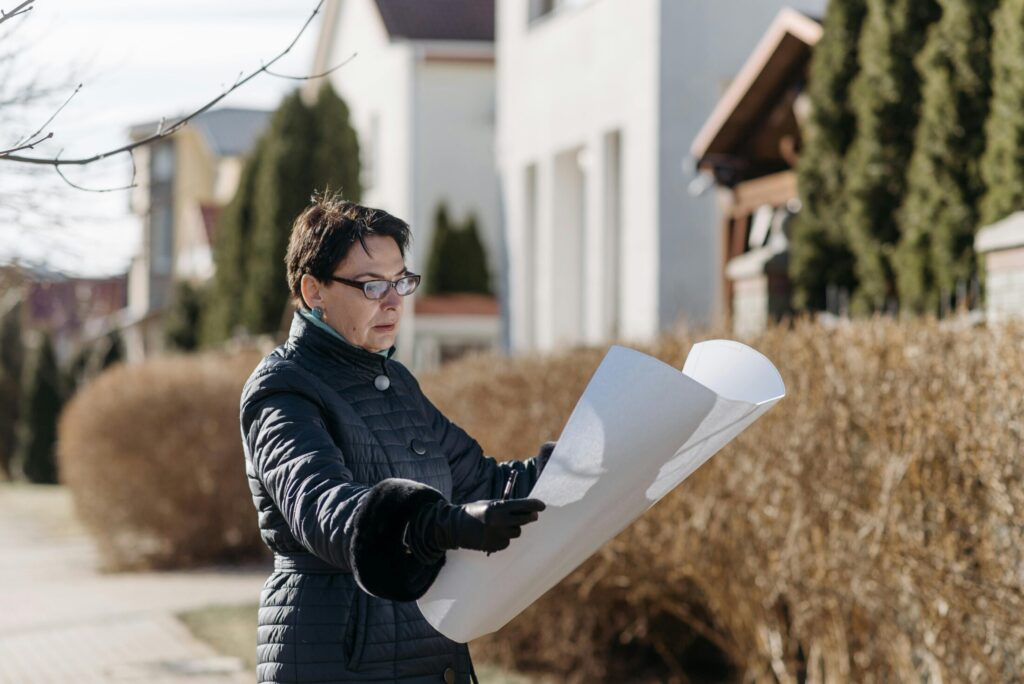 a woman in black jacket holding white paper